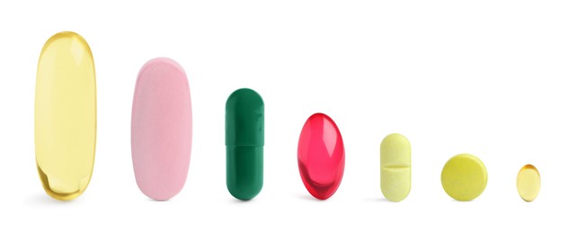 Image of Different pills in row isolated on white, set