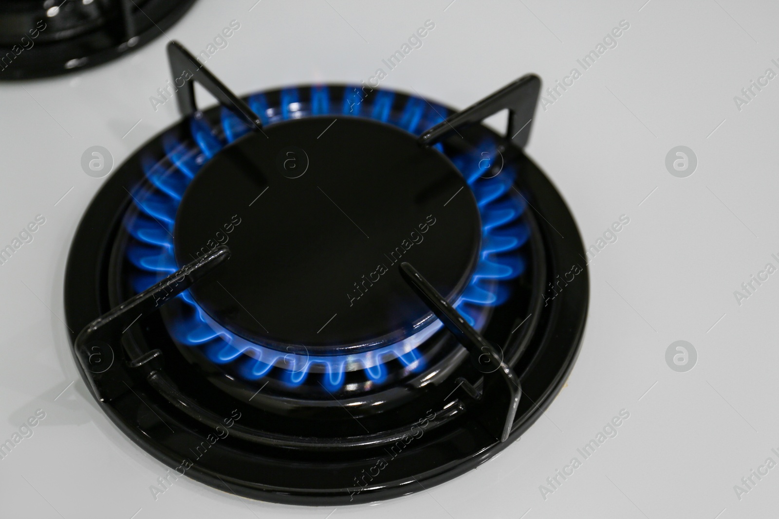 Photo of Modern kitchen stove with burning gas, above view