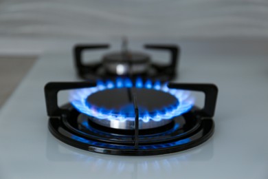 Photo of Modern kitchen stove with burning gas indoors