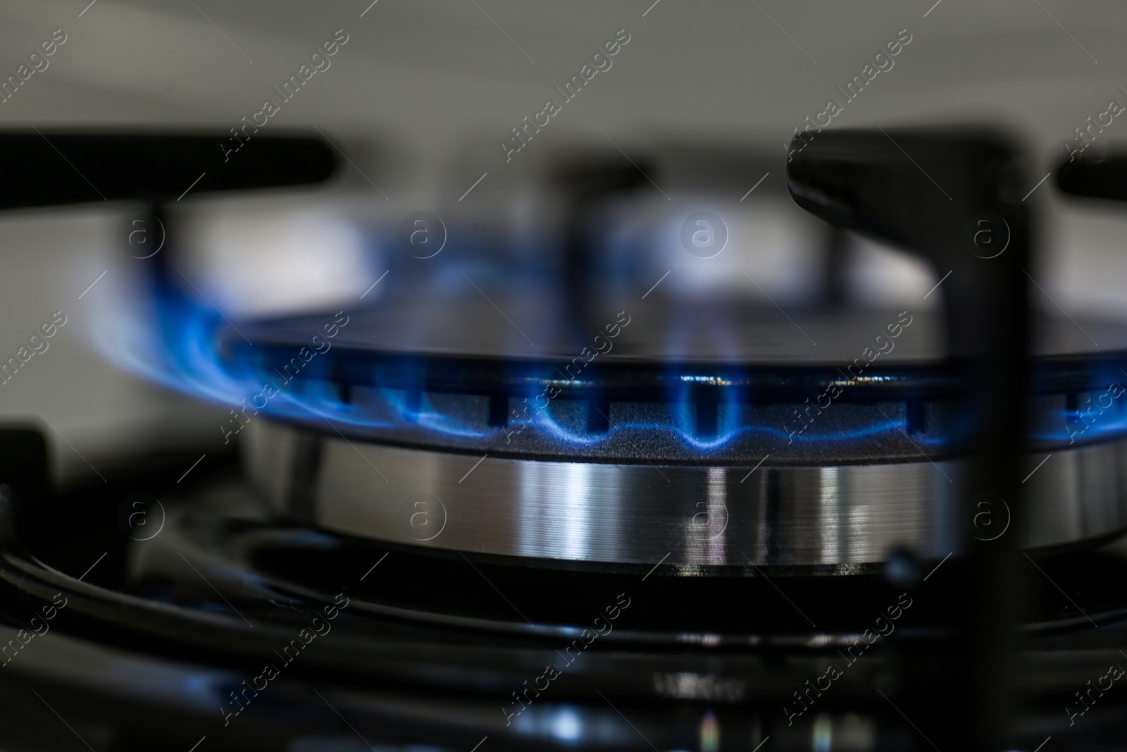 Photo of Modern kitchen stove with burning gas, closeup