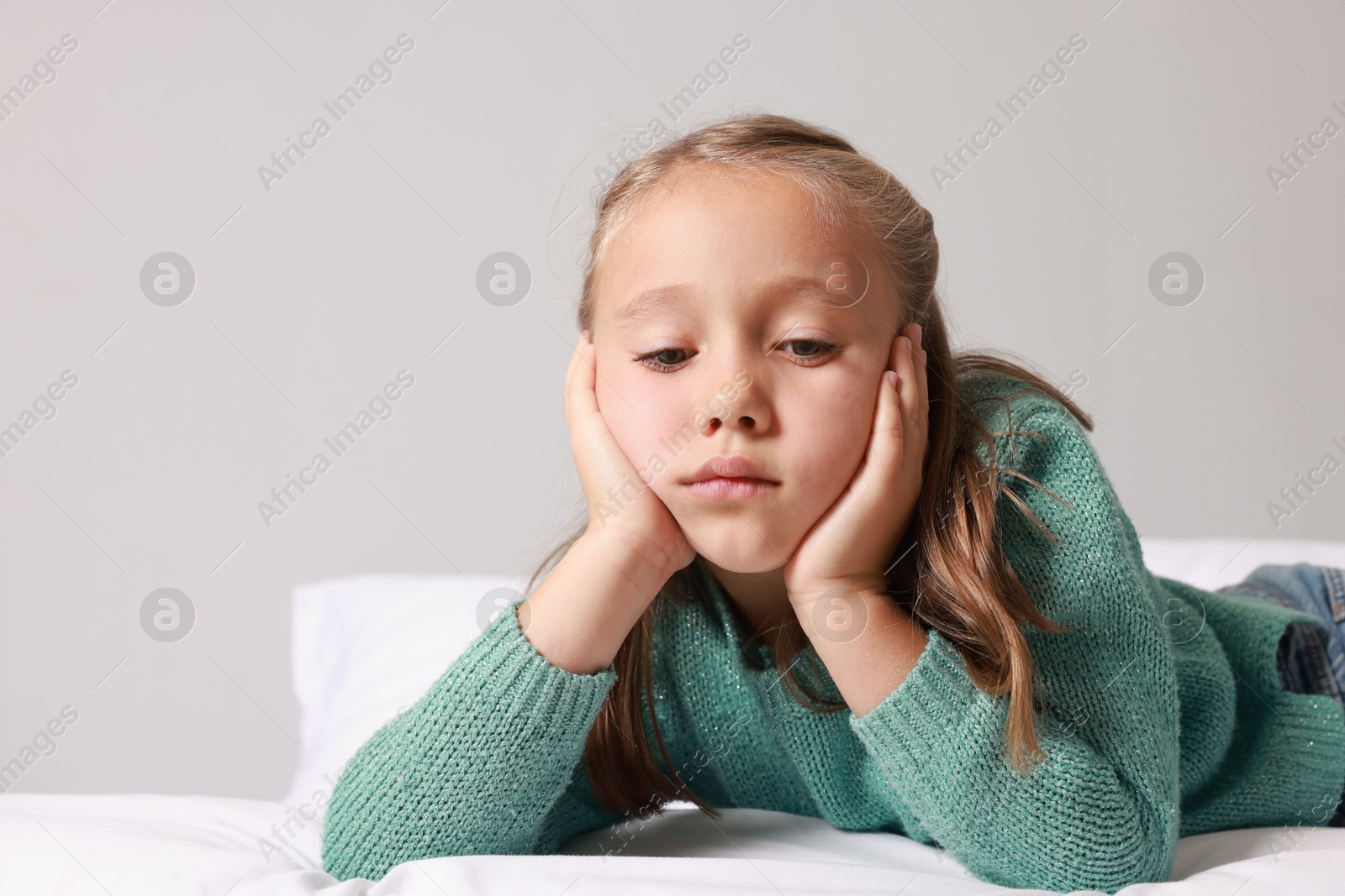 Photo of Autism concept. Lonely little girl on bed at home