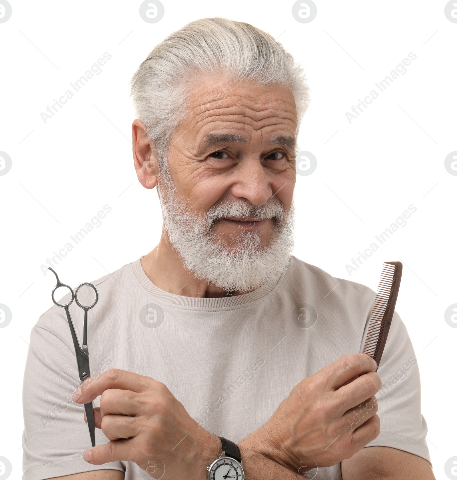 Photo of Bearded senior man holding comb and scissors on white background