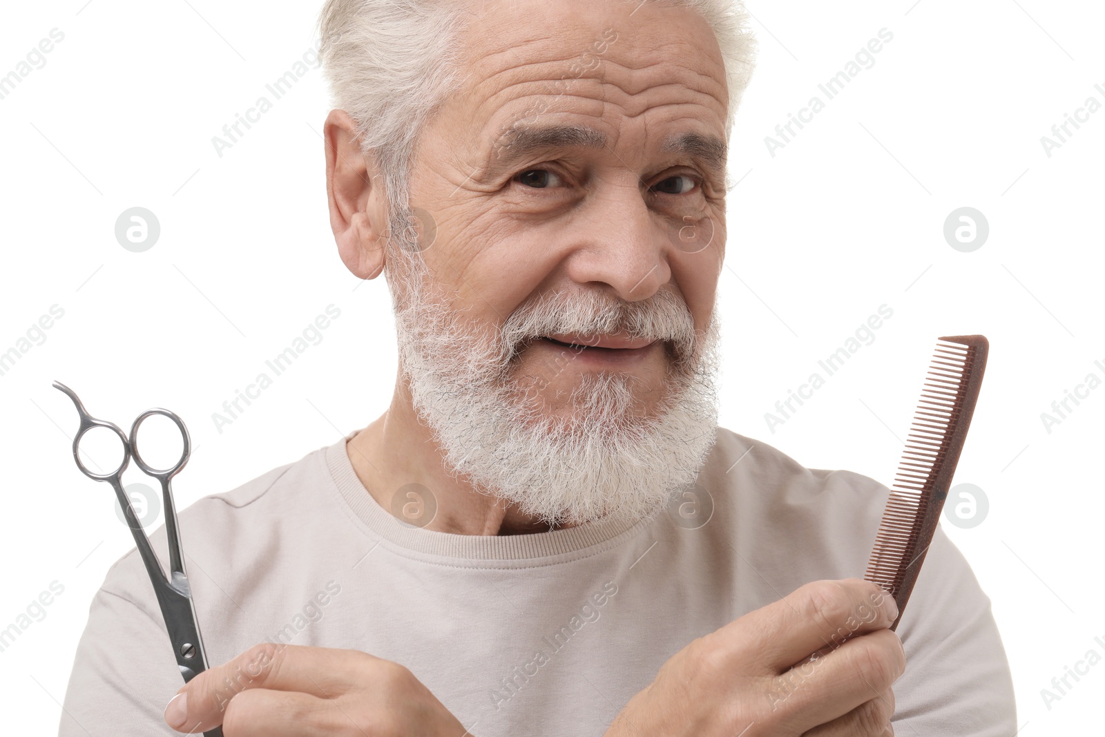 Photo of Bearded senior man holding comb and scissors on white background