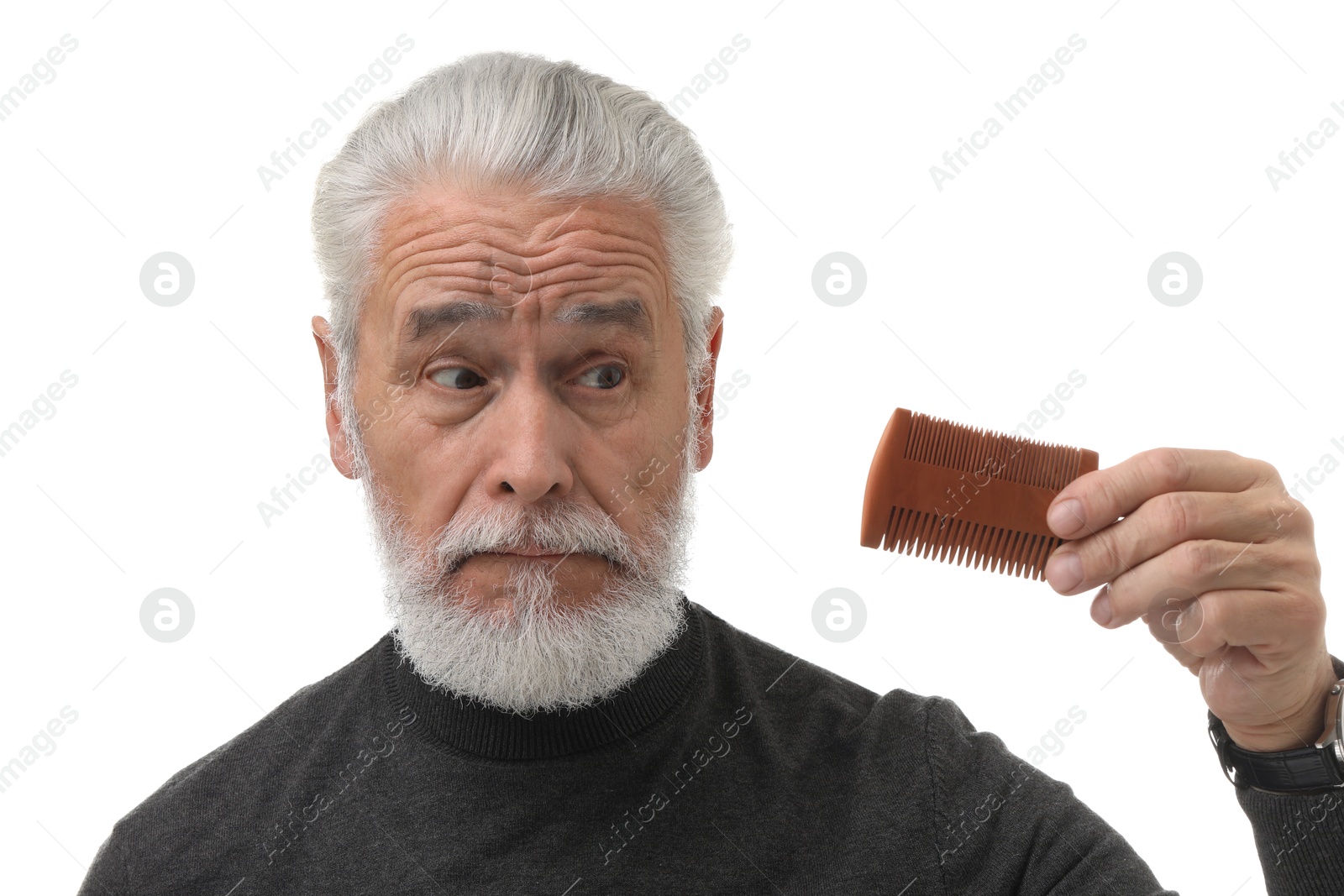 Photo of Bearded senior man holding comb on white background