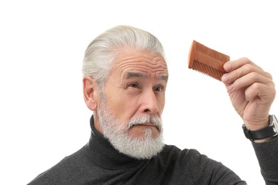 Photo of Bearded senior man holding comb on white background