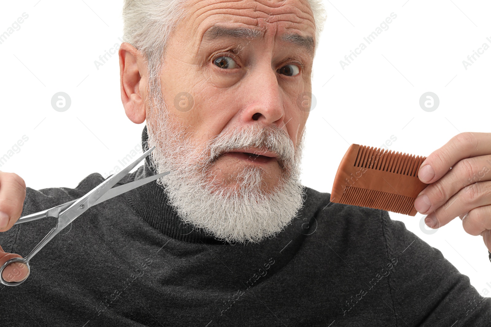 Photo of Bearded senior man holding comb and scissors on white background