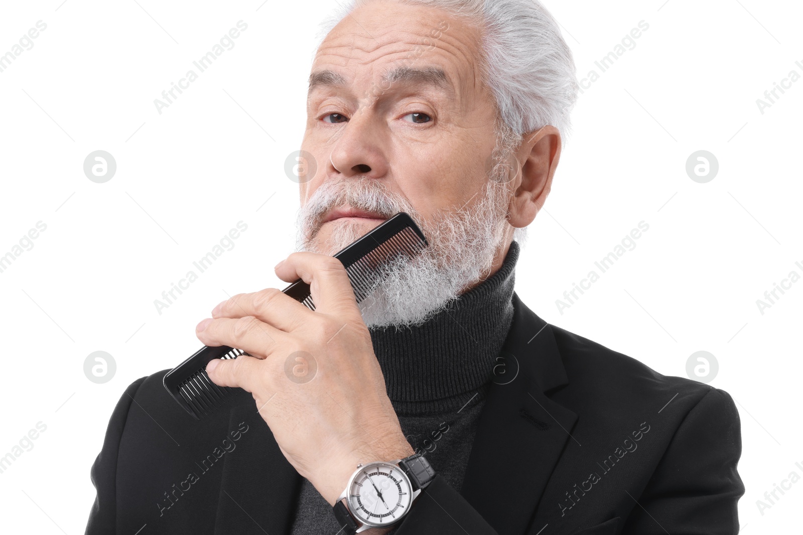 Photo of Senior man combing beard on white background