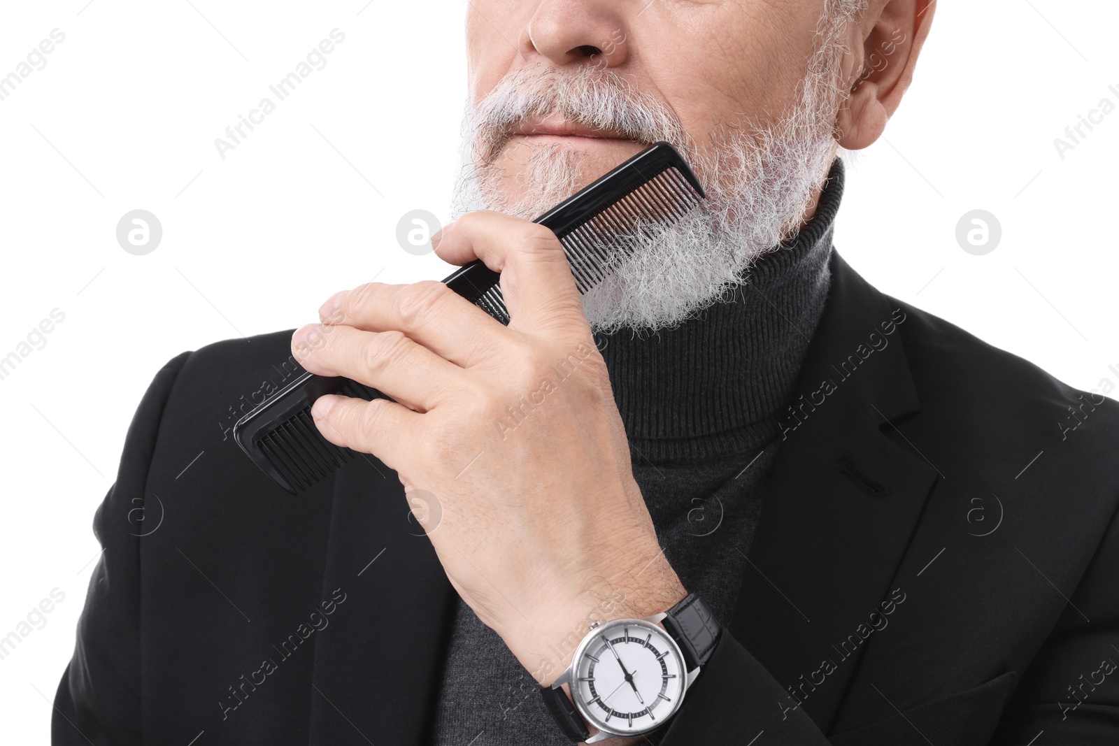 Photo of Senior man combing beard on white background, closeup