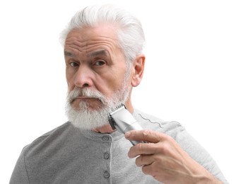 Senior man trimming beard on white background