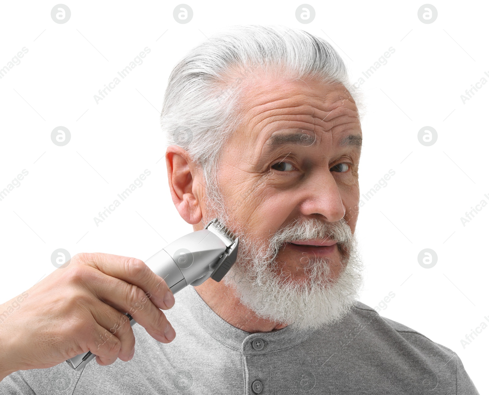 Photo of Senior man trimming beard on white background