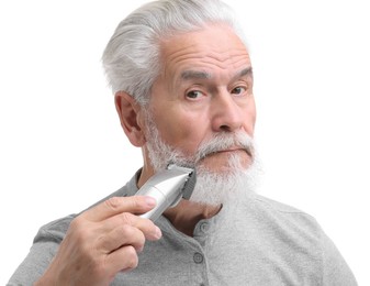 Photo of Senior man trimming beard on white background