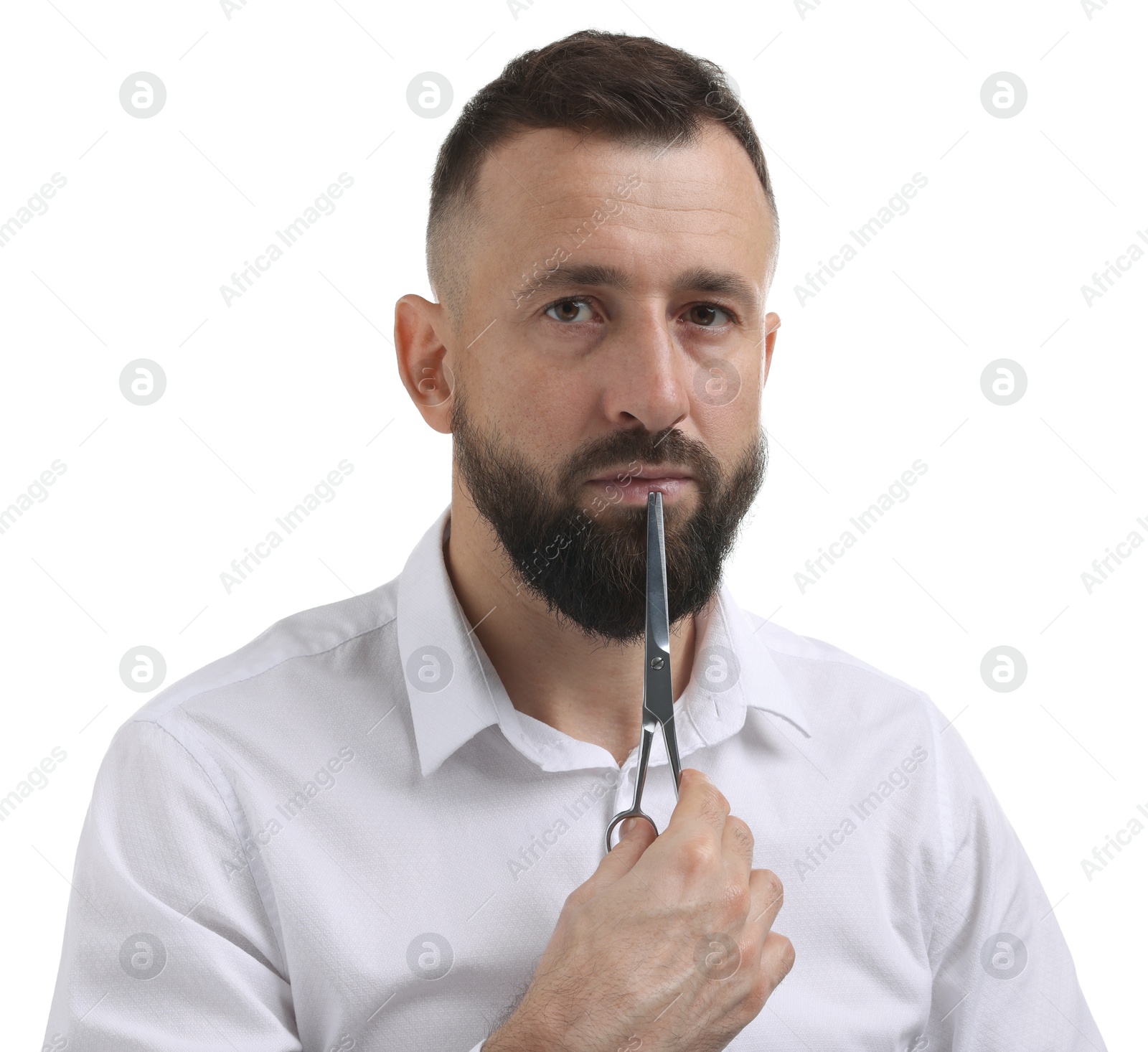 Photo of Bearded man holding scissors on white background