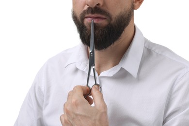 Bearded man holding scissors on white background, closeup