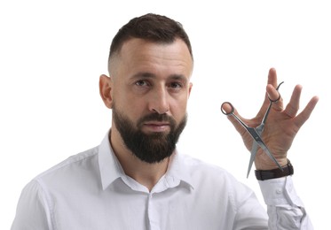 Photo of Bearded man holding scissors on white background