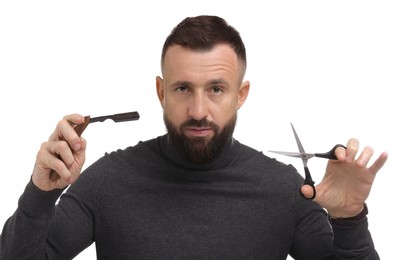 Photo of Bearded man holding blade and scissors on white background