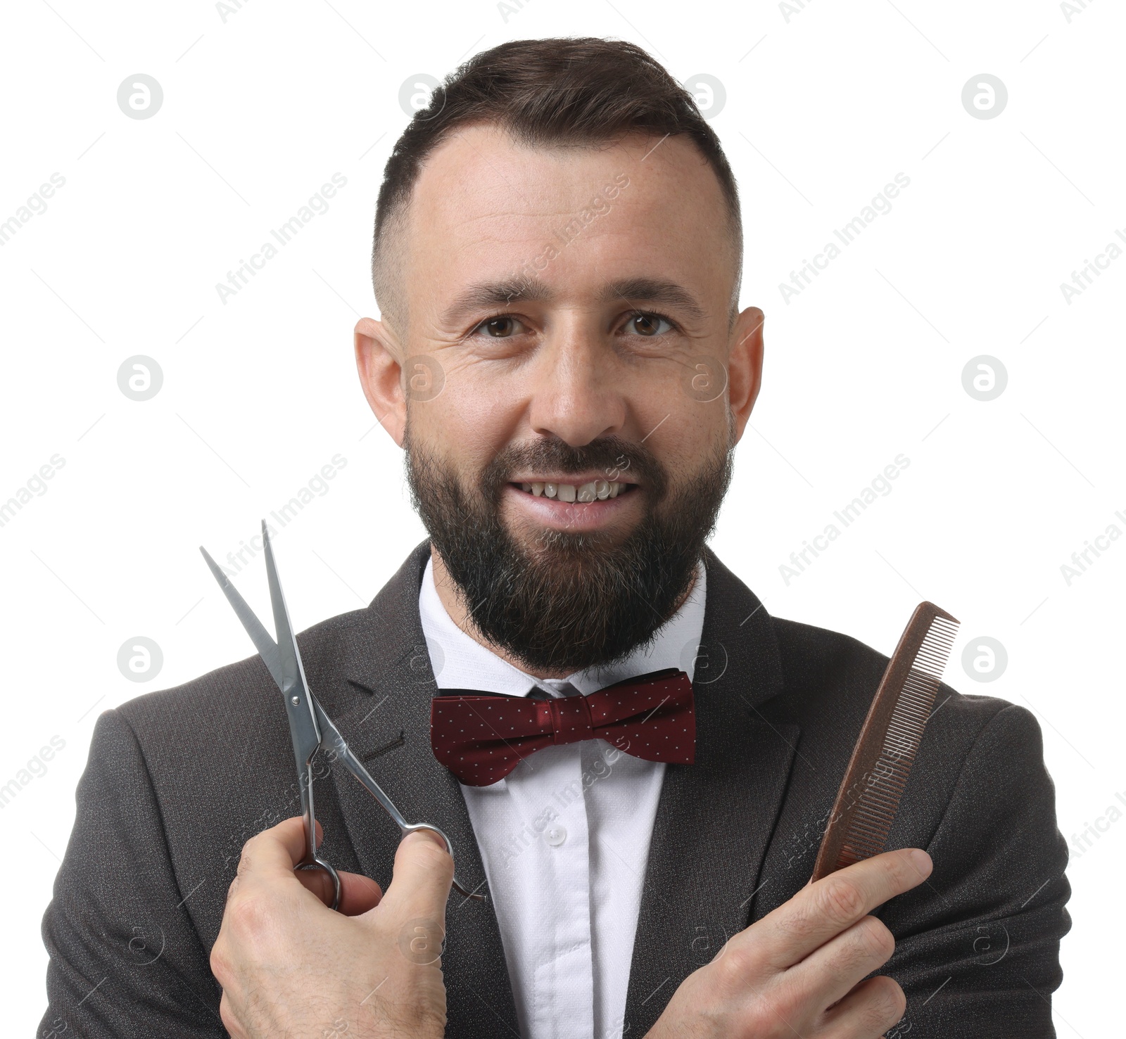 Photo of Bearded man holding comb and scissors on white background