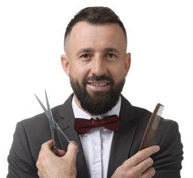 Bearded man holding comb and scissors on white background