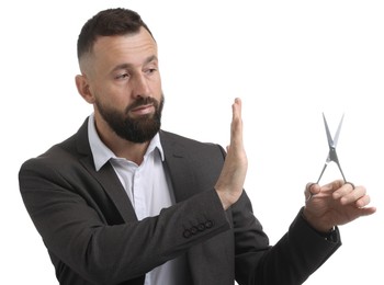 Photo of Bearded man with scissors making stop gesture on white background