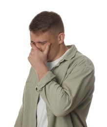 Photo of Distressed young man crying on white background