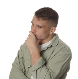 Distressed young man crying on white background