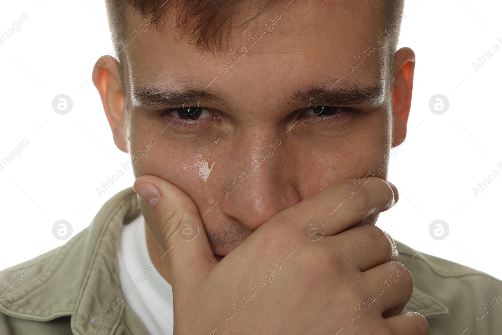 Photo of Distressed young man crying on white background