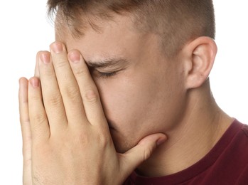 Photo of Distressed young man crying on white background