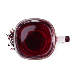 Photo of Delicious hibiscus tea in glass cup and dry roselle sepals isolated on white, top view