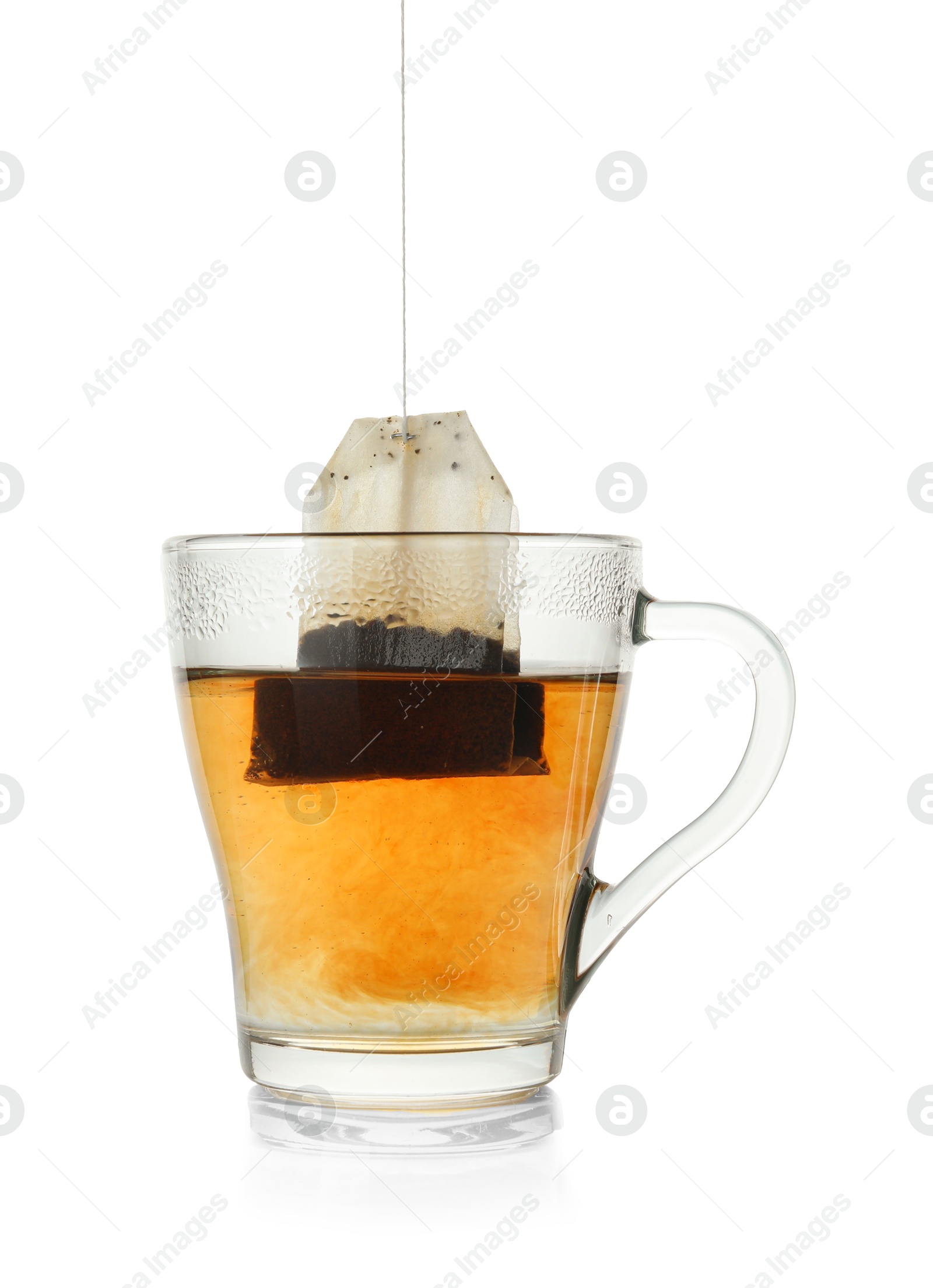 Photo of Brewing aromatic tea. Cup with teabag isolated on white