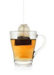 Photo of Brewing aromatic tea. Cup with teabag isolated on white