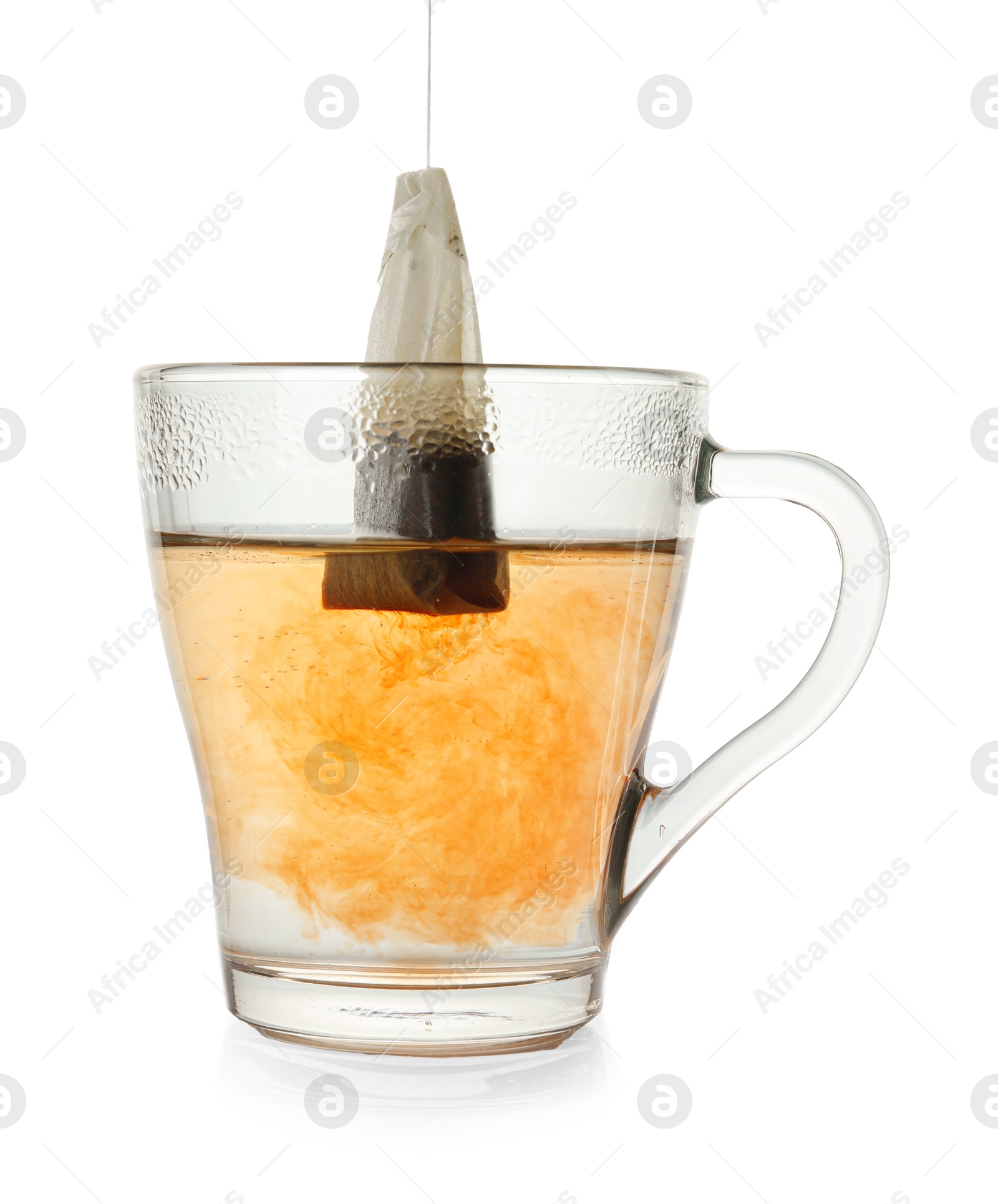 Photo of Brewing aromatic tea. Cup with teabag isolated on white