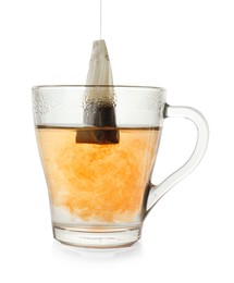 Photo of Brewing aromatic tea. Cup with teabag isolated on white