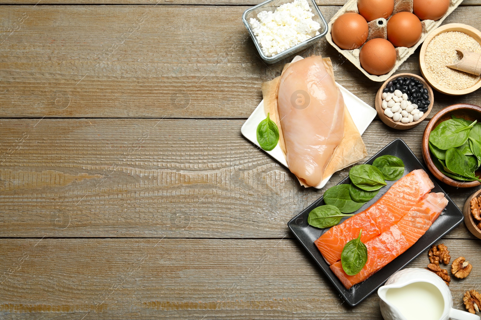 Photo of Different products rich in estrogen on wooden table, flat lay. Space for text