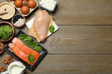 Photo of Different products rich in estrogen on wooden table, flat lay. Space for text