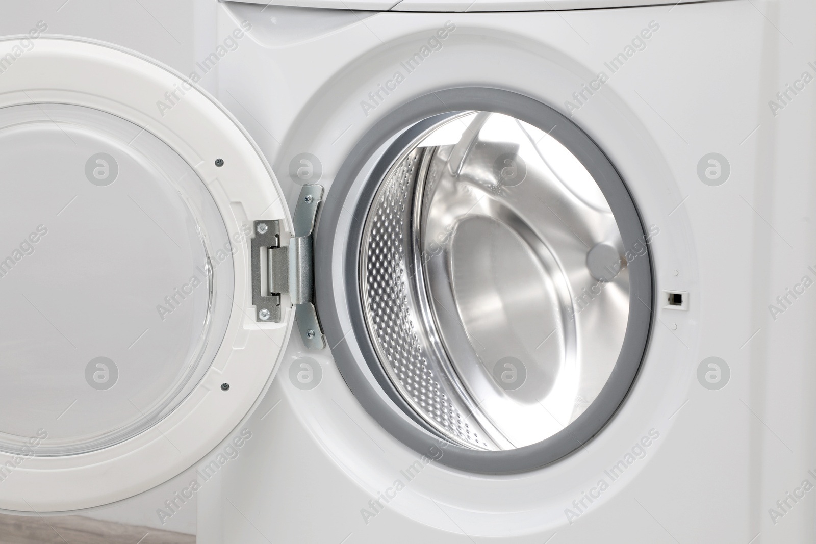 Photo of Washing machine with empty drum as background, closeup