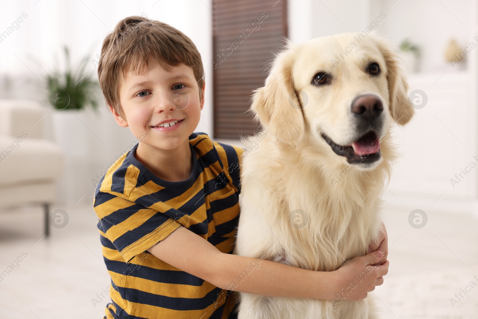 Photo of Boy with his cute dog at home