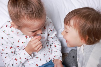 Photo of Sister and brother spending time together at home