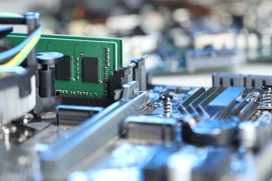 Photo of Computer motherboard with RAM chip as background, closeup. Electronic engineering