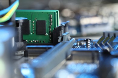 Photo of Computer motherboard with RAM chip as background, closeup. Electronic engineering