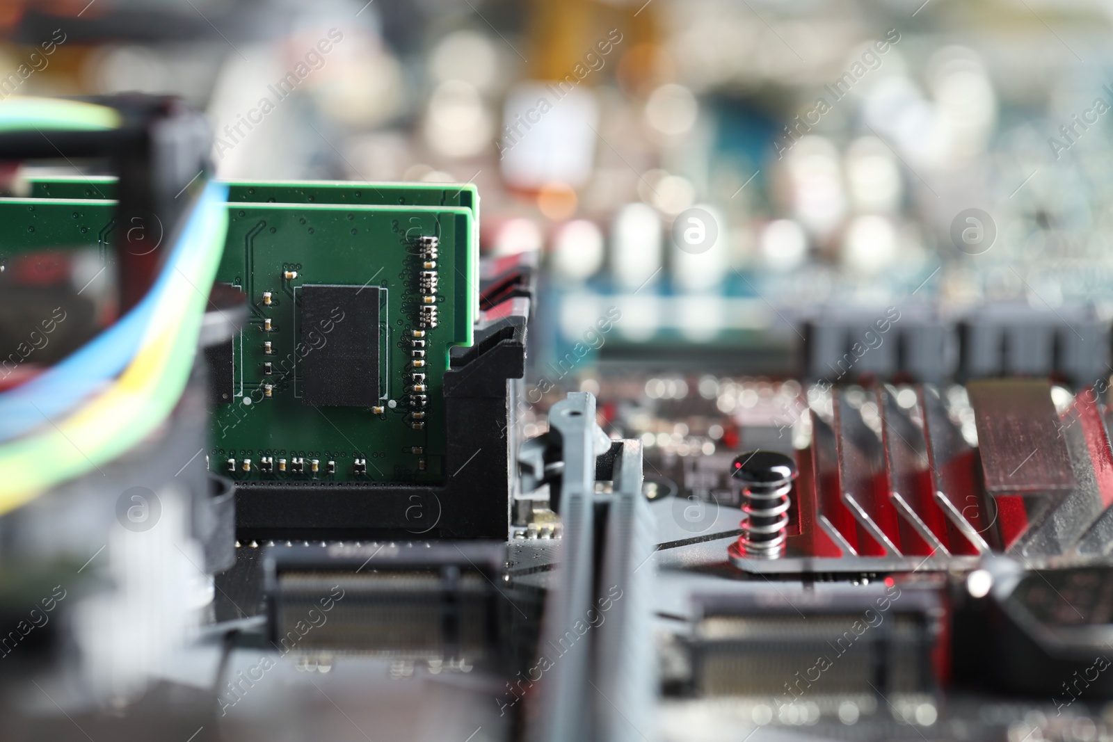 Photo of Computer motherboard with RAM chip as background, closeup. Electronic engineering