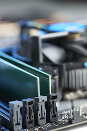 Photo of Computer motherboard with RAM chip as background, closeup. Electronic engineering