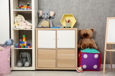 Photo of Beautiful kid's room interior with toys and stylish furniture