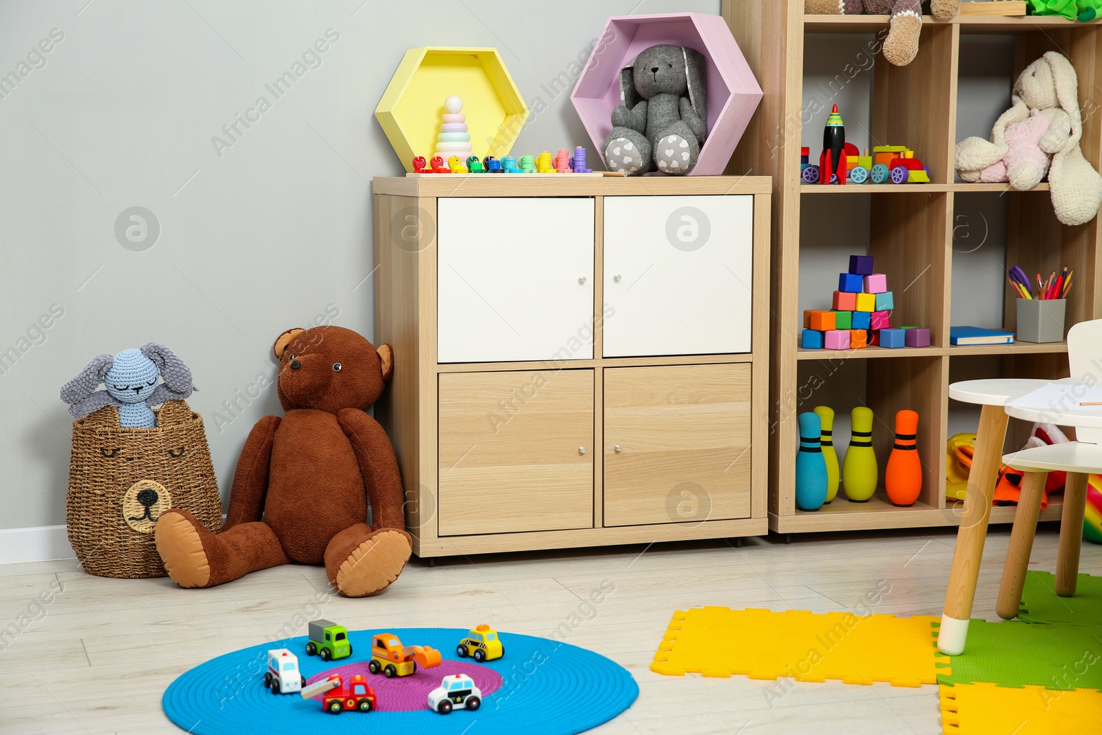 Photo of Beautiful kid's room interior with toys and stylish furniture