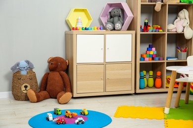 Photo of Beautiful kid's room interior with toys and stylish furniture