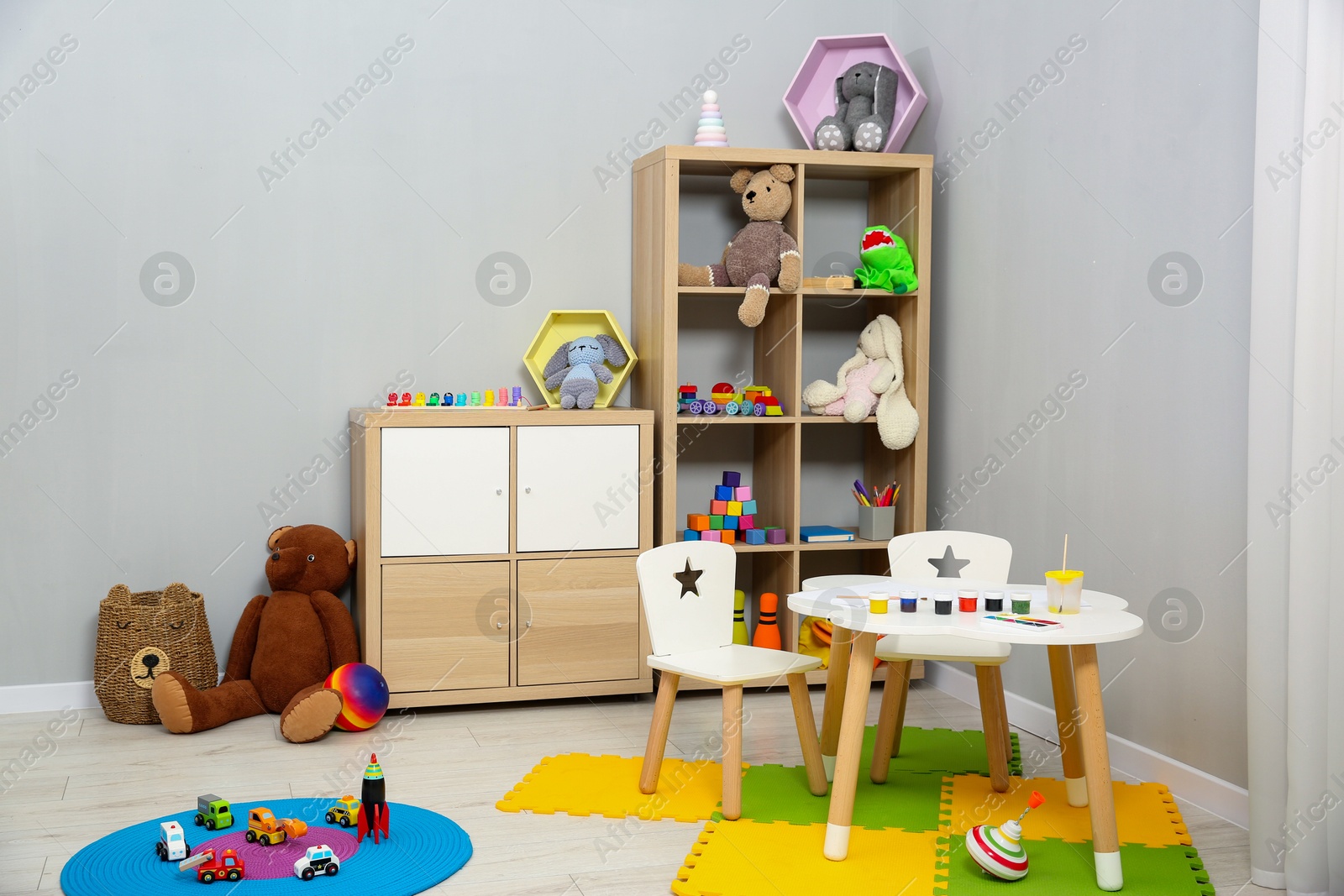 Photo of Beautiful kid's room interior with toys and stylish furniture