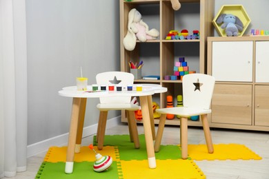 Photo of Beautiful kid's room interior with toys and stylish furniture