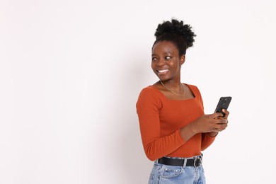 Photo of Happy woman with smartphone on white background. Space for text