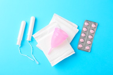 Photo of Flat lay composition with menstrual products on light blue background