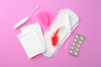 Photo of Flat lay composition with menstrual products on violet background