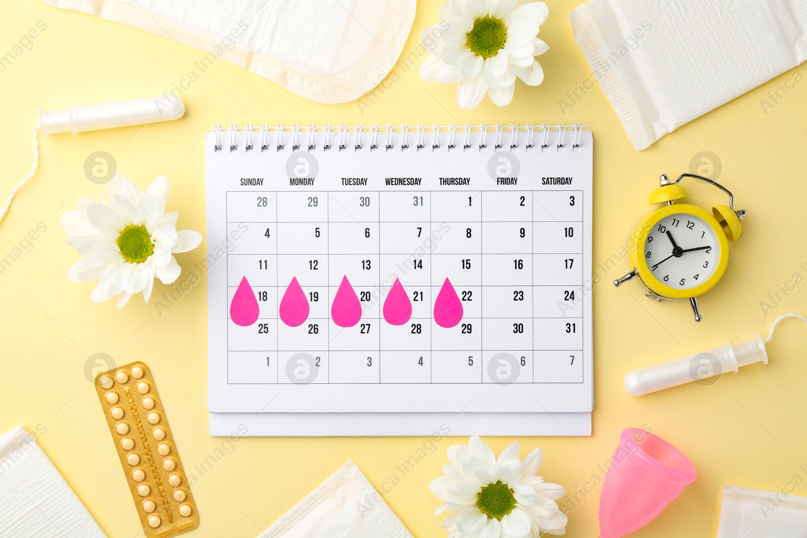 Photo of Flat lay composition with calendar and menstrual products on beige background