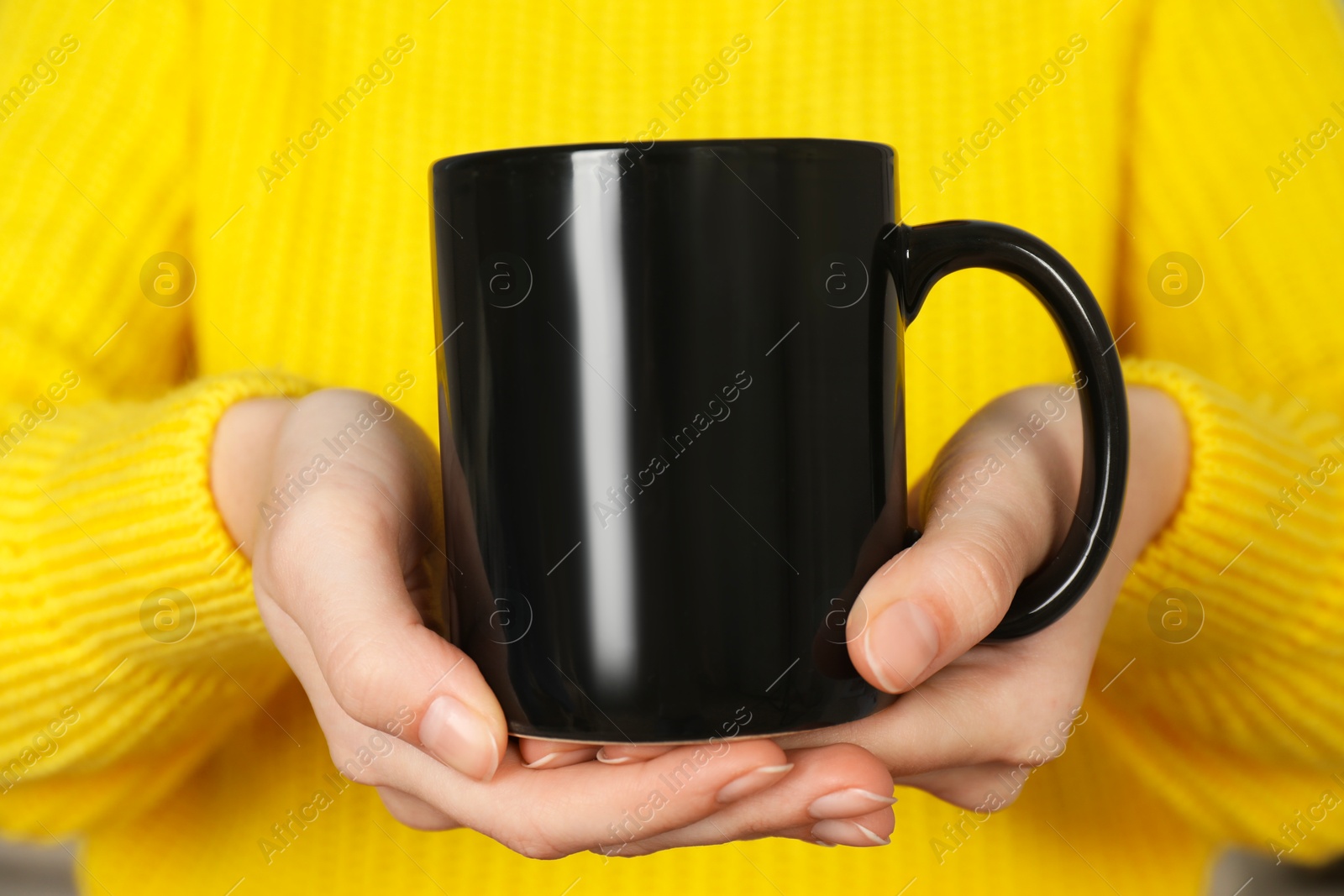 Photo of Woman with black ceramic cup, closeup. Mockup for design